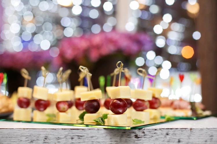 Grape, pineapple cubes and cheese on wooden skewers