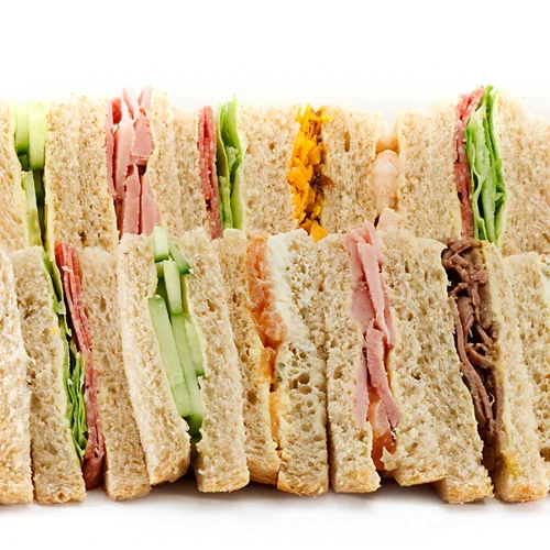 A platter of triangular sandwiches